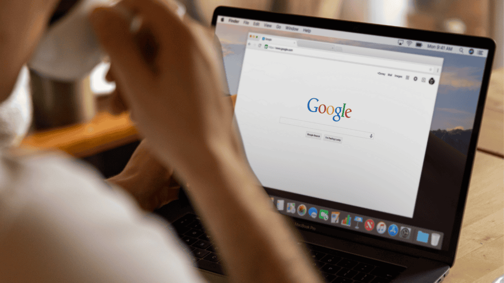 Person using a laptop with the Google search homepage open